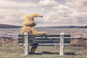 man in a bunny suit on a bench
